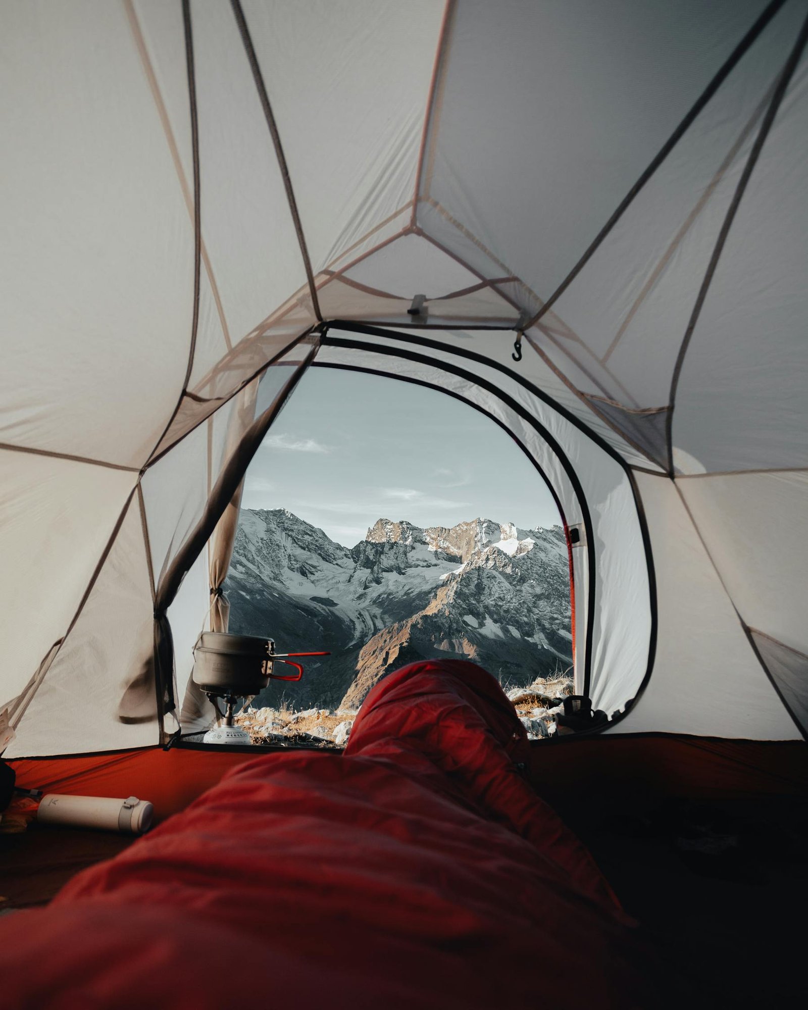 High mountain campsite viewed from inside a tent