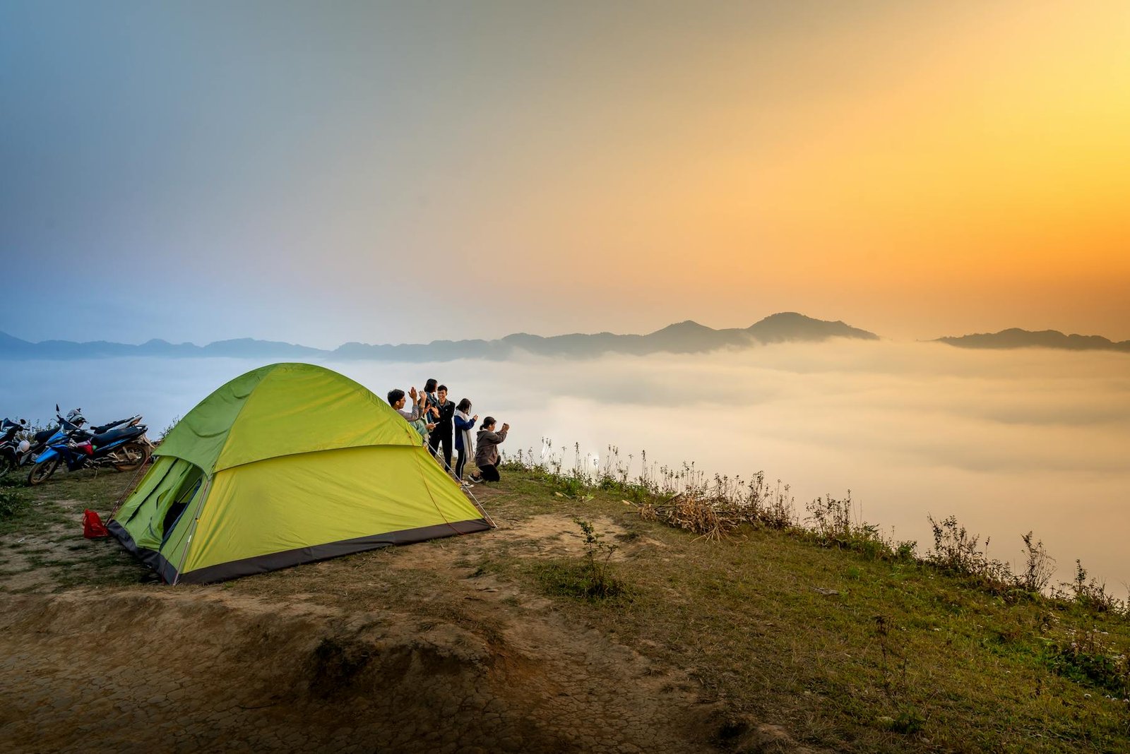 Campsite above a sea of clouds at sunrise